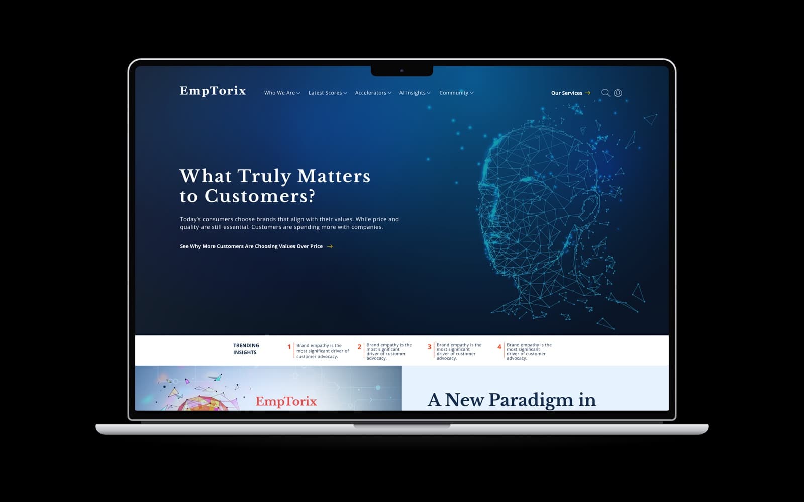 The Emptorix home page on a MacBook Pro, with a polygon-mesh face beside the headline "What Truly Matters to Customers?"